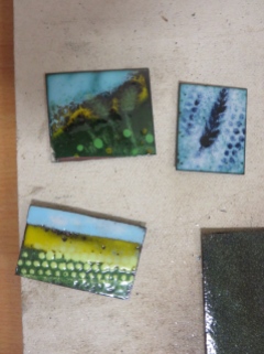 A selection of enamels which are cooling after being in the kiln. The wheat sheaf is mine!