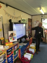 Ridges & Furrows historian Dave Reeves teaching the children of Welbourn Primary School about 'making your mark' which were the signatures of people who could not write.